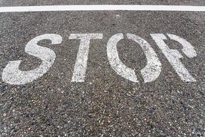 STOP sign on the road with textured asphalt. photo