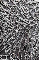 Silver paper clips textured background full screen photo