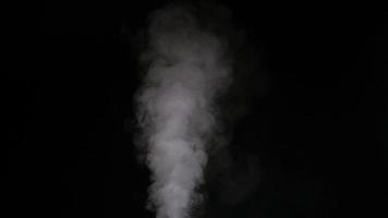 Slow motion of white smoke, fog, mist, vapor on a black background.
