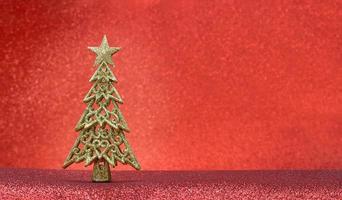 Christmas tree on a red background with glitter, sparkles with place for text. New Year. Copy space photo