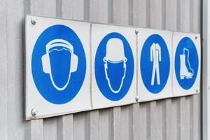 Prescriptive safety signs and posters of personal protective equipment at work. photo