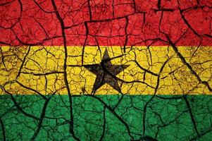 Dry soil pattern on the flag of Ghana. Country with drought concept. Water problem. Dry cracked earth country. photo