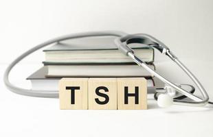 tsh word on wooden cubes and stethoscope photo