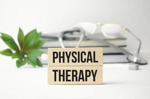 physical therapy words on wooden blocks and stethoscope photo