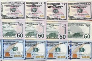 Many one hundred and fifty dollar bills on flat background surface close up. Flat lay top view photo