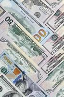 Many one hundred and fifty dollar bills on flat background surface close up. Flat lay top view photo