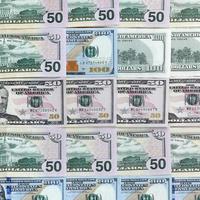 Many one hundred and fifty dollar bills on flat background surface close up. Flat lay top view photo