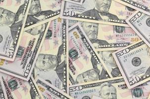 Many US fifty dollar bills on flat background surface close up. Flat lay top view. Abstract business concept photo