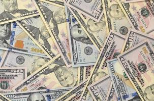 Many one hundred and fifty dollar bills on flat background surface close up. Flat lay top view photo