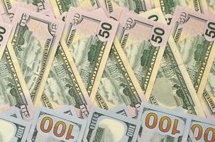 Many one hundred and fifty dollar bills on flat background surface close up. Flat lay top view photo