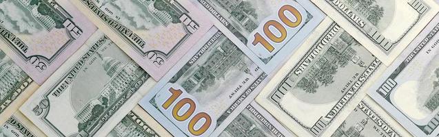 Many one hundred and fifty dollar bills on flat background surface close up. Flat lay top view photo