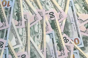 Many one hundred and fifty dollar bills on flat background surface close up. Flat lay top view photo