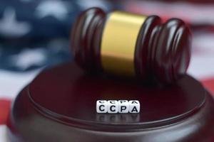 Justice mallet and CCPA acronym with US flag on background. California consumer protection act photo