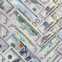 Many one hundred and fifty dollar bills on flat background surface close up. Flat lay top view photo