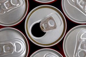 Many cans of soda soft drink or energy drink containers. A lot of recycled cans made from aluminum and being prepared for re-production. photo