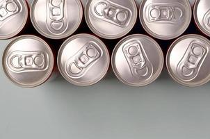 Many new aluminium cans of soda soft drink or energy drink containers. Drinks manufacturing concept and mass production photo