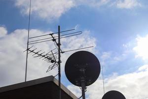 A satellite dish against blue sky photo