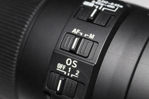 Close up view at a dslr camera objective autofocus switch. photo