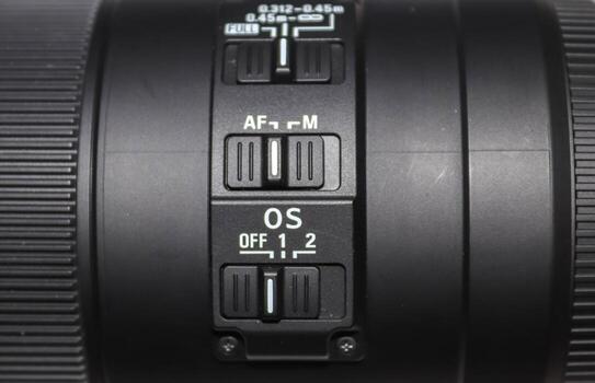 Close up view at a dslr camera objective autofocus switch. photo