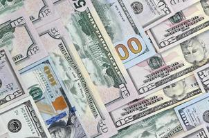 Many one hundred and fifty dollar bills on flat background surface close up. Flat lay top view photo