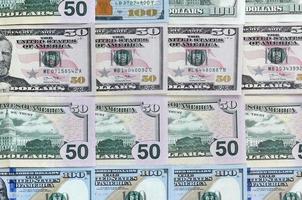 Many one hundred and fifty dollar bills on flat background surface close up. Flat lay top view photo