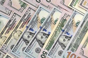 Many one hundred and fifty dollar bills on flat background surface close up. Flat lay top view photo