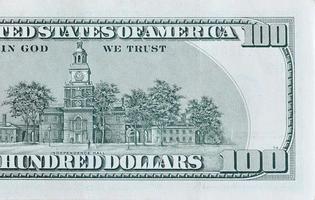 Independence Hall on 100 dollars banknote back side closeup macro fragment. United states hundred dollars money bill photo