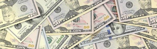 Many one hundred and fifty dollar bills on flat background surface close up. Flat lay top view photo
