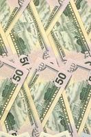 Many one hundred and fifty dollar bills on flat background surface close up. Flat lay top view photo
