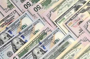 Many one hundred and fifty dollar bills on flat background surface close up. Flat lay top view photo
