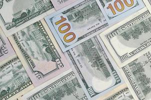 Many one hundred and fifty dollar bills on flat background surface close up. Flat lay top view photo