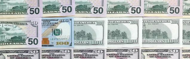 Many one hundred and fifty dollar bills on flat background surface close up. Flat lay top view photo