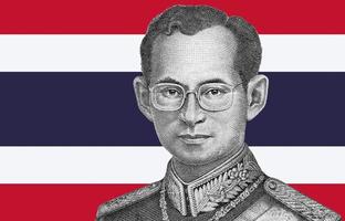 Portrait of King Bhumibol Adulyadej from 50 Baht Thailand money bill close on Thailand flag background photo