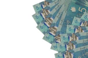 5 Canadian dollars bills lies isolated on white background with copy space. Rich life conceptual background photo