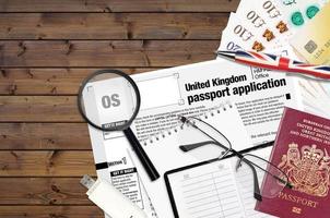 English form OS United Kingdom passport application from HM passport office lies on table with office items. UK passport paperwork photo