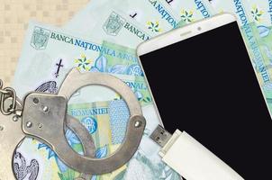1 Romanian leu bills and smartphone with police handcuffs. Concept of hackers phishing attacks, illegal scam or malware soft distribution photo