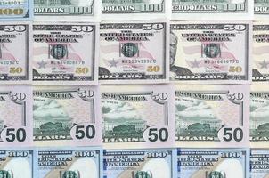 Many one hundred and fifty dollar bills on flat background surface close up. Flat lay top view photo