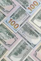Many one hundred and fifty dollar bills on flat background surface close up. Flat lay top view photo