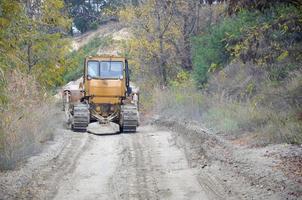 Quarry aggregate with heavy duty machinery. Caterpillar loader Excavator with backhoe driving to construction site quarry photo