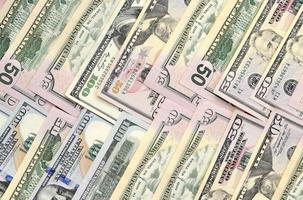 Many one hundred and fifty dollar bills on flat background surface close up. Flat lay top view photo