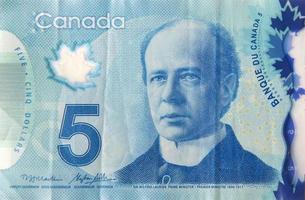 retrato de sir wilfrid laurier de canadá fragmento de billetes de polímero de 5 dólares de 2013 foto