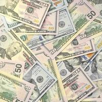 Many one hundred and fifty dollar bills on flat background surface close up. Flat lay top view photo