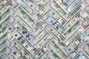 Many one hundred and fifty dollar bills on flat background surface close up. Flat lay top view photo