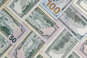 Many one hundred and fifty dollar bills on flat background surface close up. Flat lay top view photo