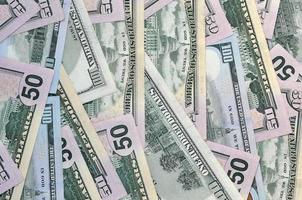 Many one hundred and fifty dollar bills on flat background surface close up. Flat lay top view photo