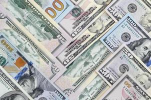 Many one hundred and fifty dollar bills on flat background surface close up. Flat lay top view photo