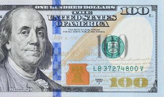 Portrait of US president Benjamin Franklin on 100 dollars banknote closeup macro fragment. United states hundred dollars money bill photo