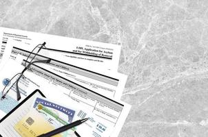 USCIS form I-589 Application of asylum and for withholding of removal lies on flat lay office table and ready to fill. U.S. Citizenship and Immigration services paperwork concept photo