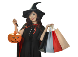 Asian girl in witch costume holding jack o lantern and shopping sale bag for halloween party trick or treat concept isolate on orange background png