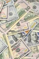 Many one hundred and fifty dollar bills on flat background surface close up. Flat lay top view photo